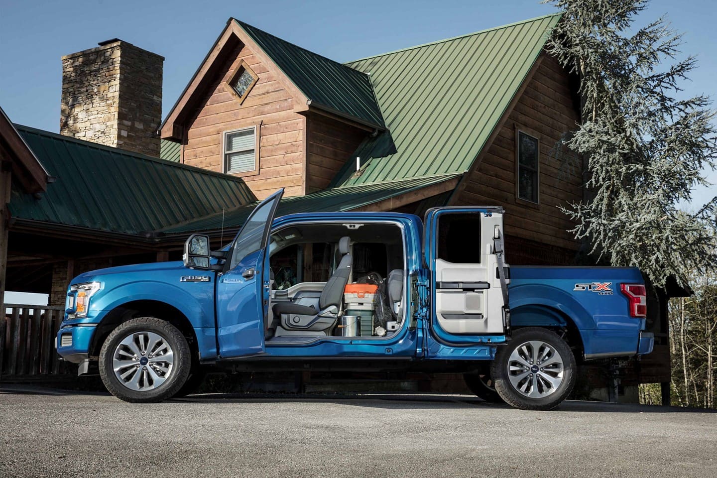 Image of a blue 2019 Ford F-150 with its doors open.